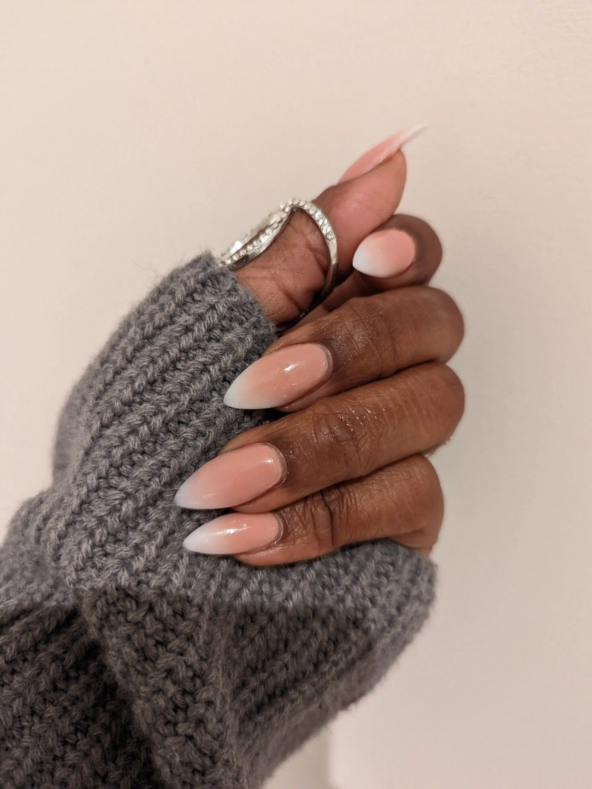 Beige negative space ombre nails with gradient creating elegant minimalist winter nail art design perfect for sophisticated neutral manicure