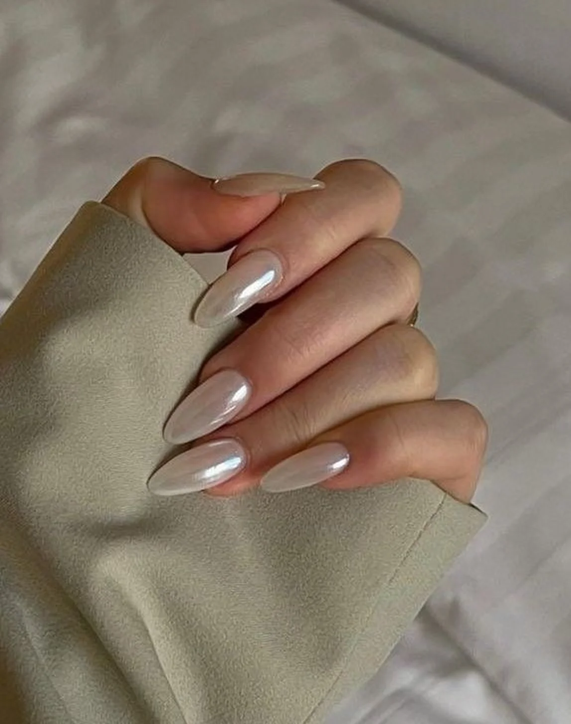 Milky white pearl accent nails creating subtle luxury minimalist winter manicure design perfect for elegant understated sophisticated style 2025