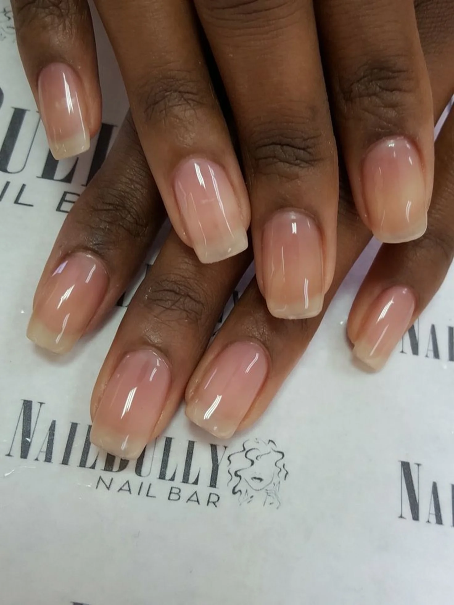 Sheer nude glossy short nails creating natural clean elegant minimalist winter manicure perfect for effortless understated beauty style