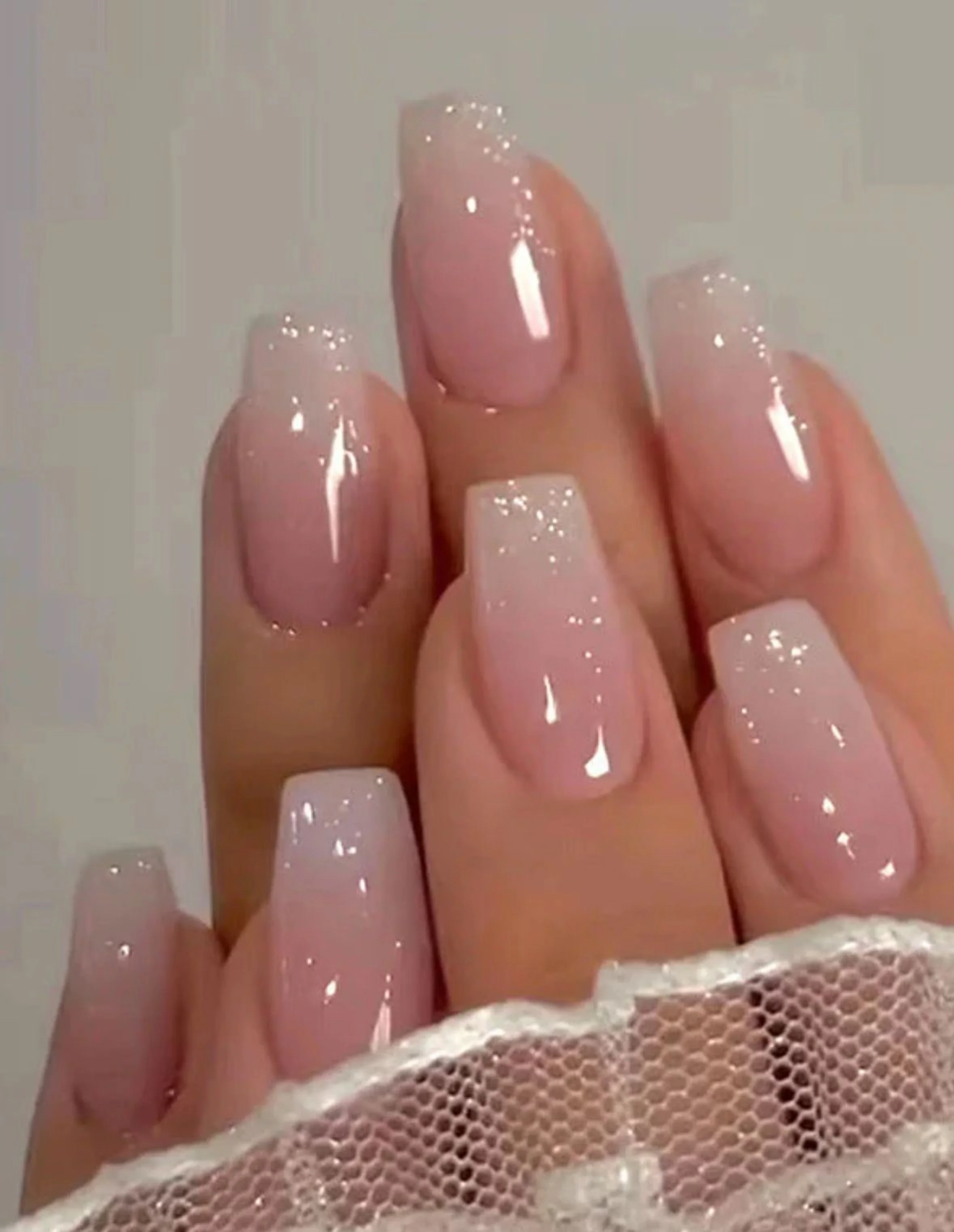 Sheer pink minimalist coffin nails with soft clean elegant jelly finish creating subtle winter manicure perfect for romantic style