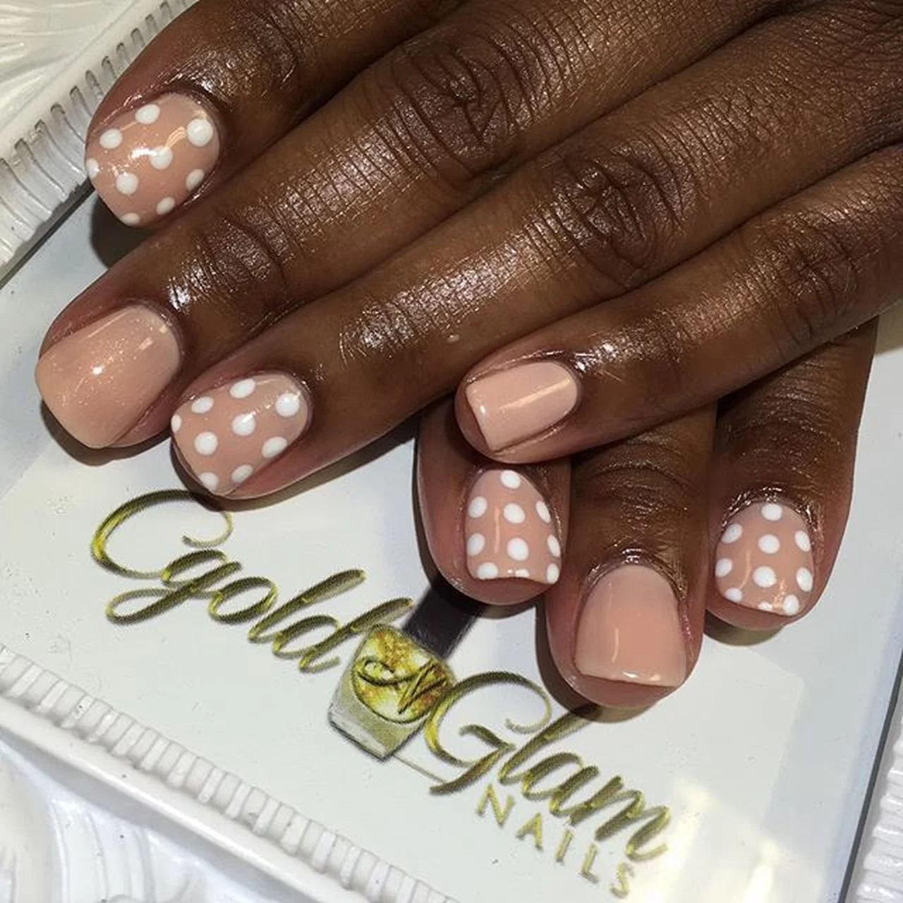 Soft pink micro dots nails with subtle accent creating minimalist winter manicure trendy design perfect for delicate feminine style 2025