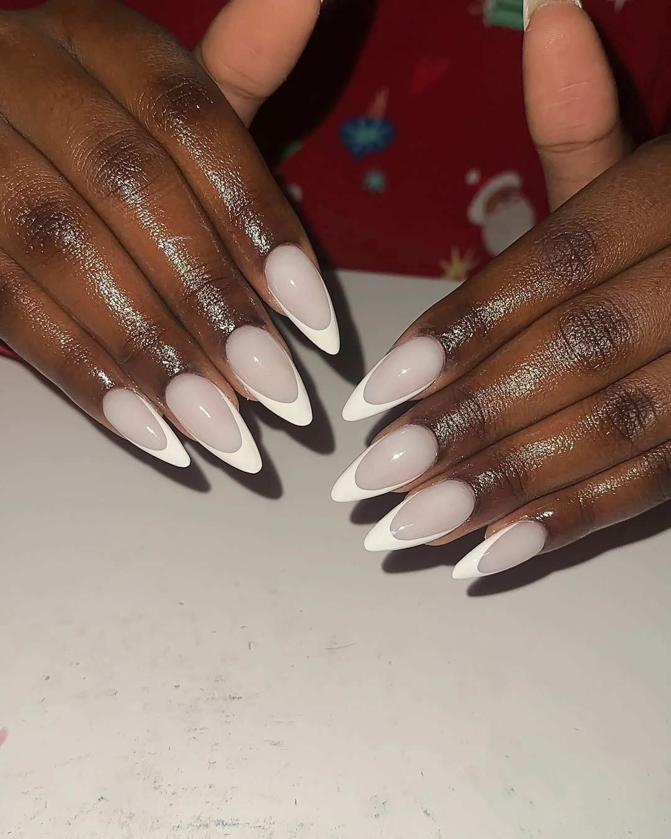 White thin French tip almond nails creating classic modern minimalist winter manicure perfect for timeless elegant professional style 2025