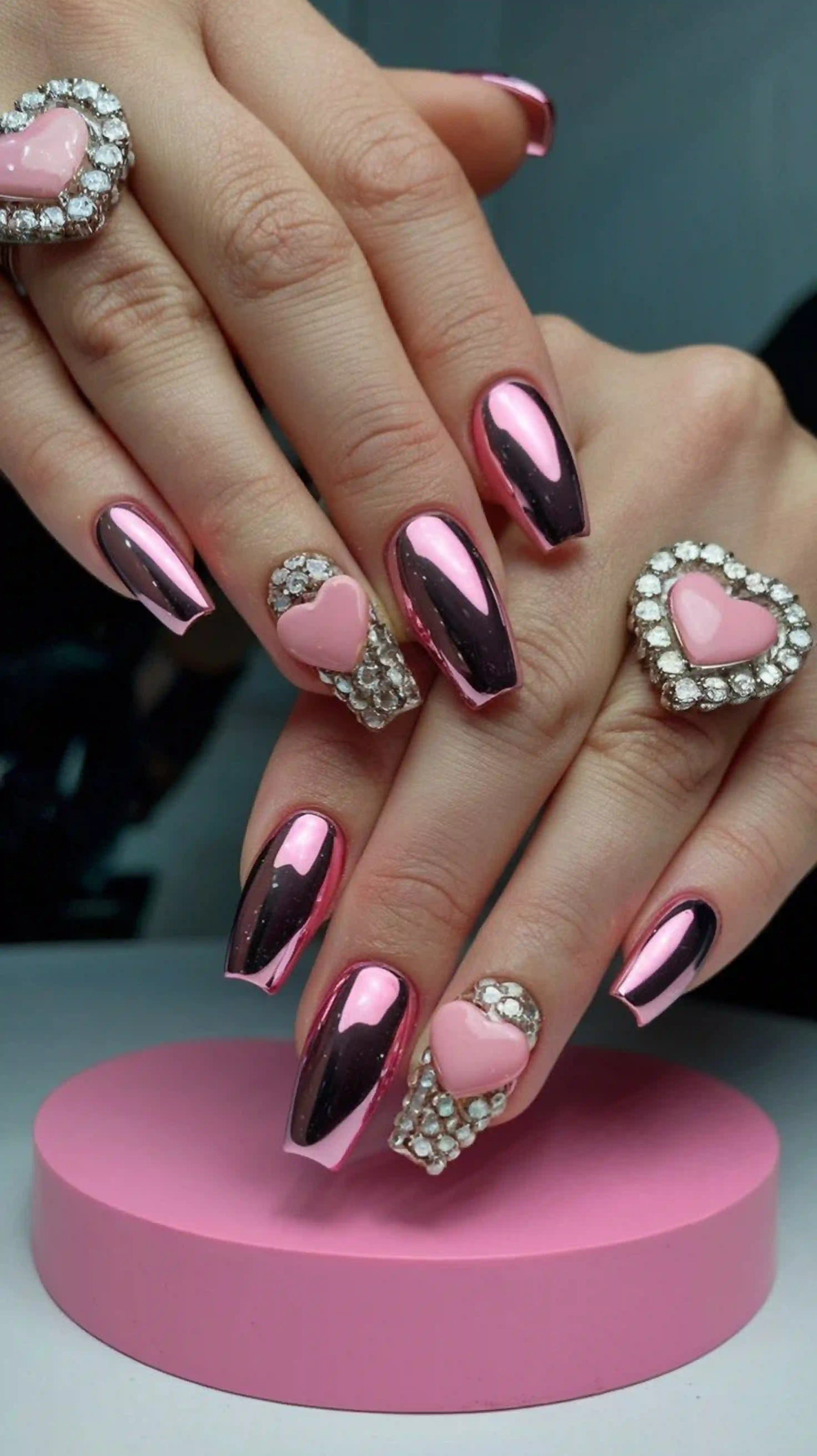 Pink chrome hearts metallic modern valentine nails creating trendy dimensional bold manicure style