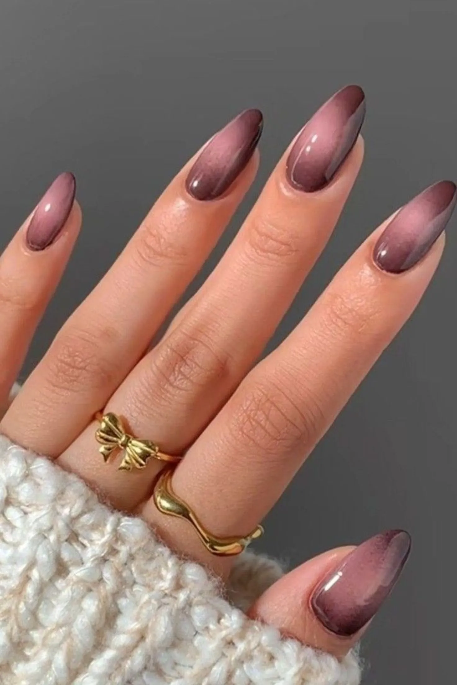 Burgundy velvet ombre cat eye nails with gradient magnetic creating trending winter manicure design perfect for festive celebrations