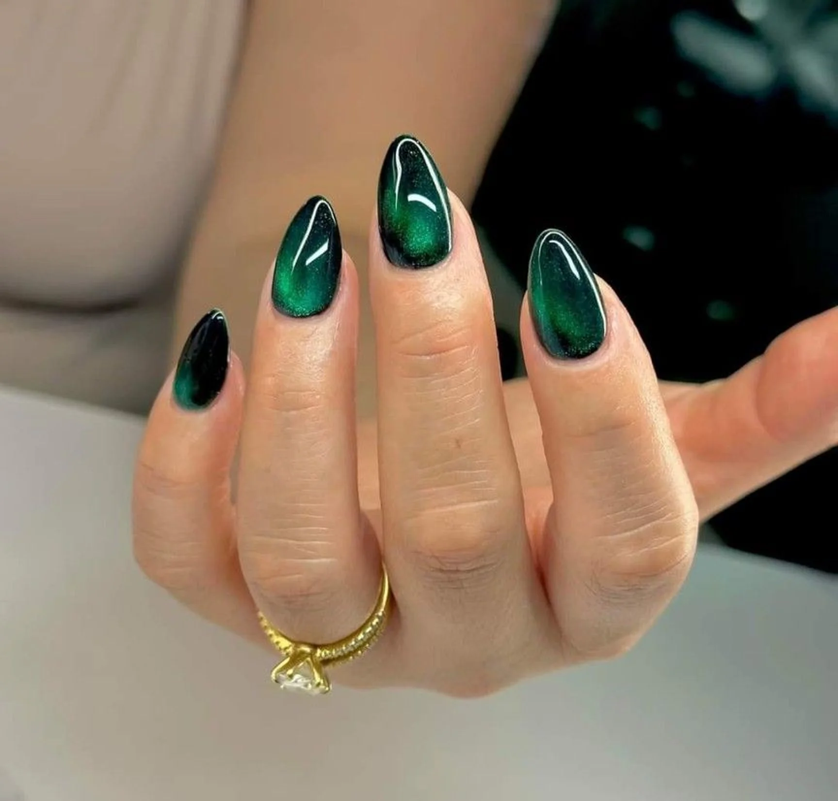 Emerald green velvet cat eye nails with magnetic dimensional finish creating luxurious winter manicure perfect for holiday party 2025