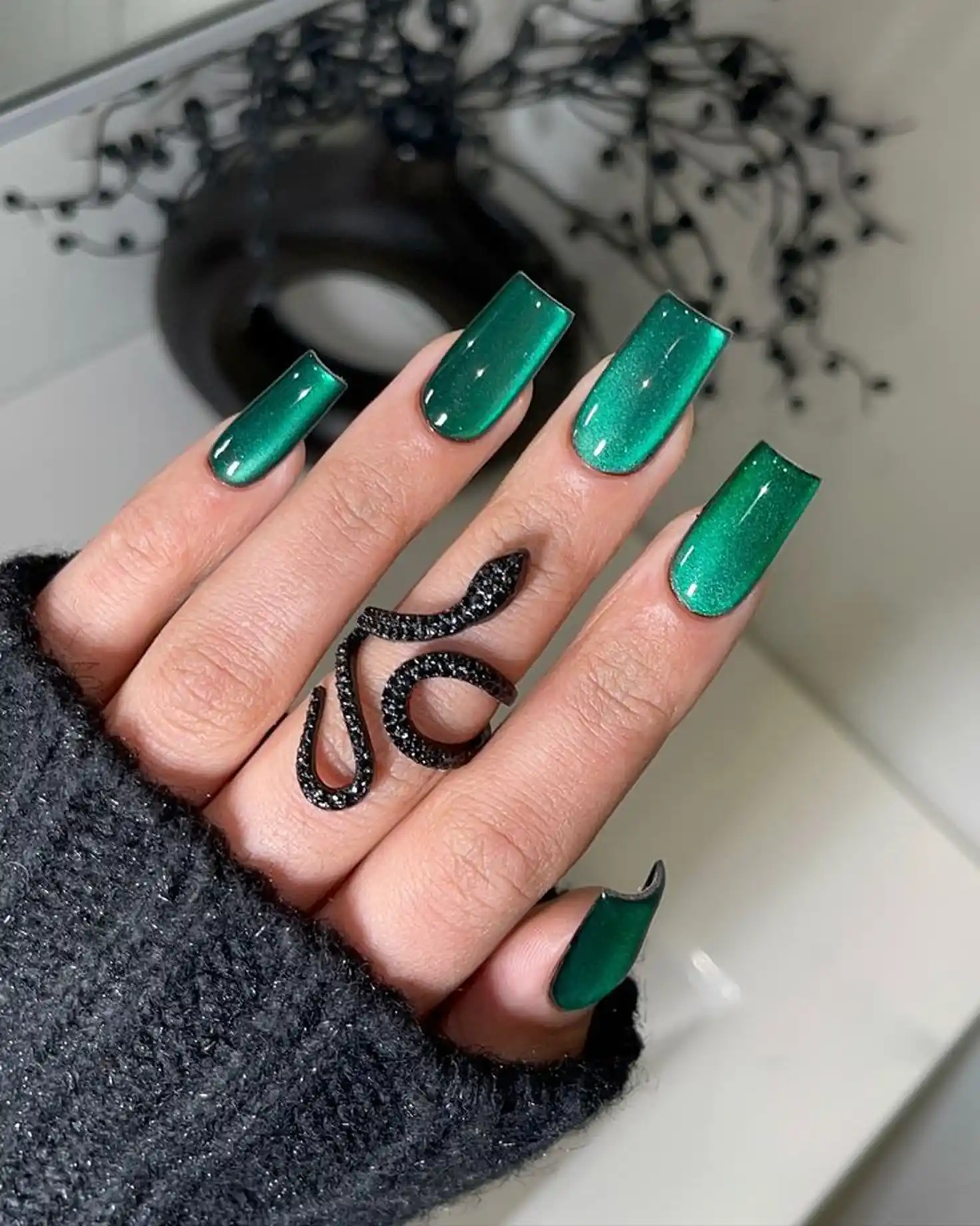 Forest green velvet coffin nails with cat eye magnetic creating rich dimensional winter manicure perfect for bold statement style