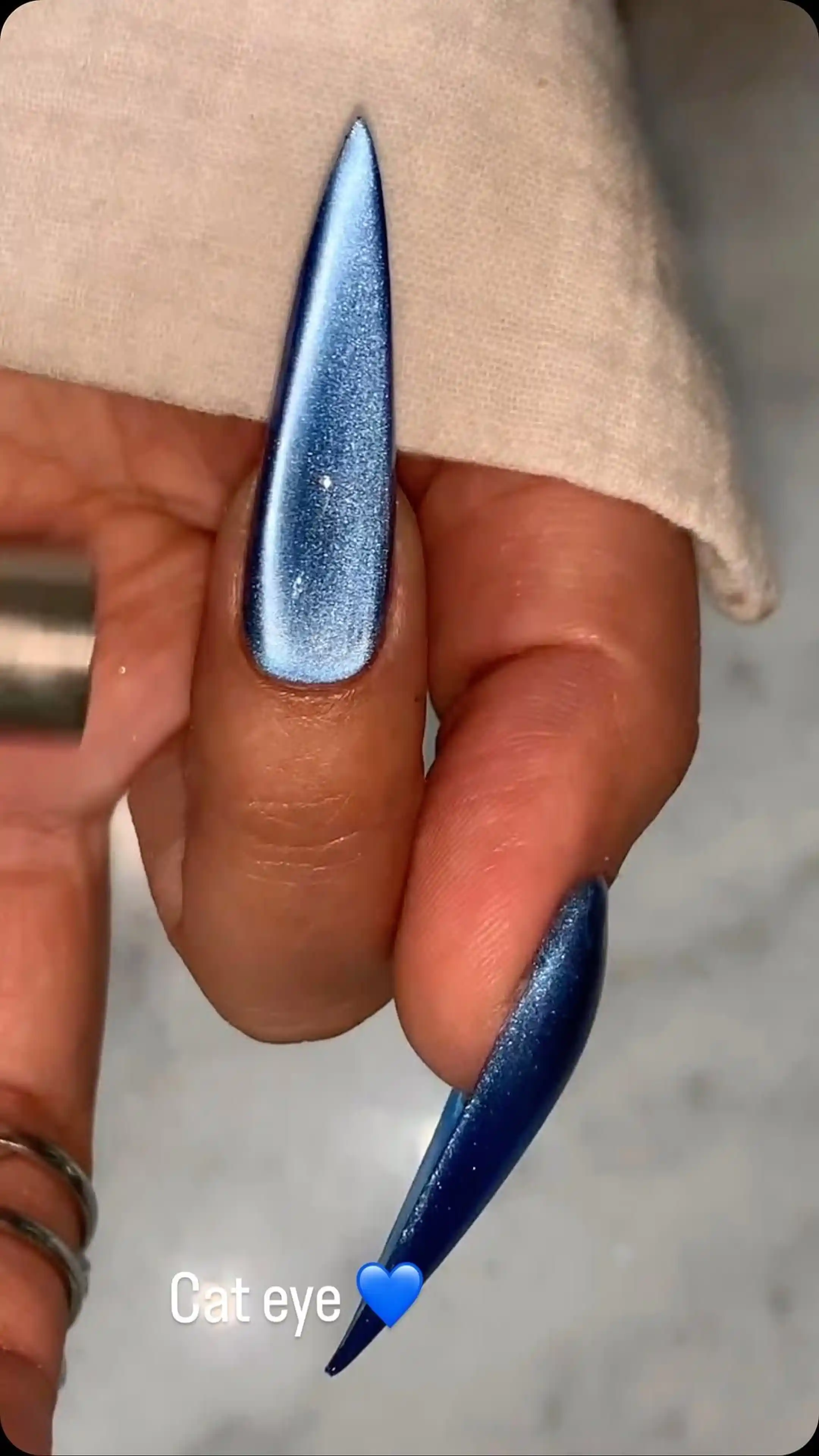 Navy blue cat eye nails with dimensional magnetic velvet effect creating sophisticated winter manicure perfect for professional style