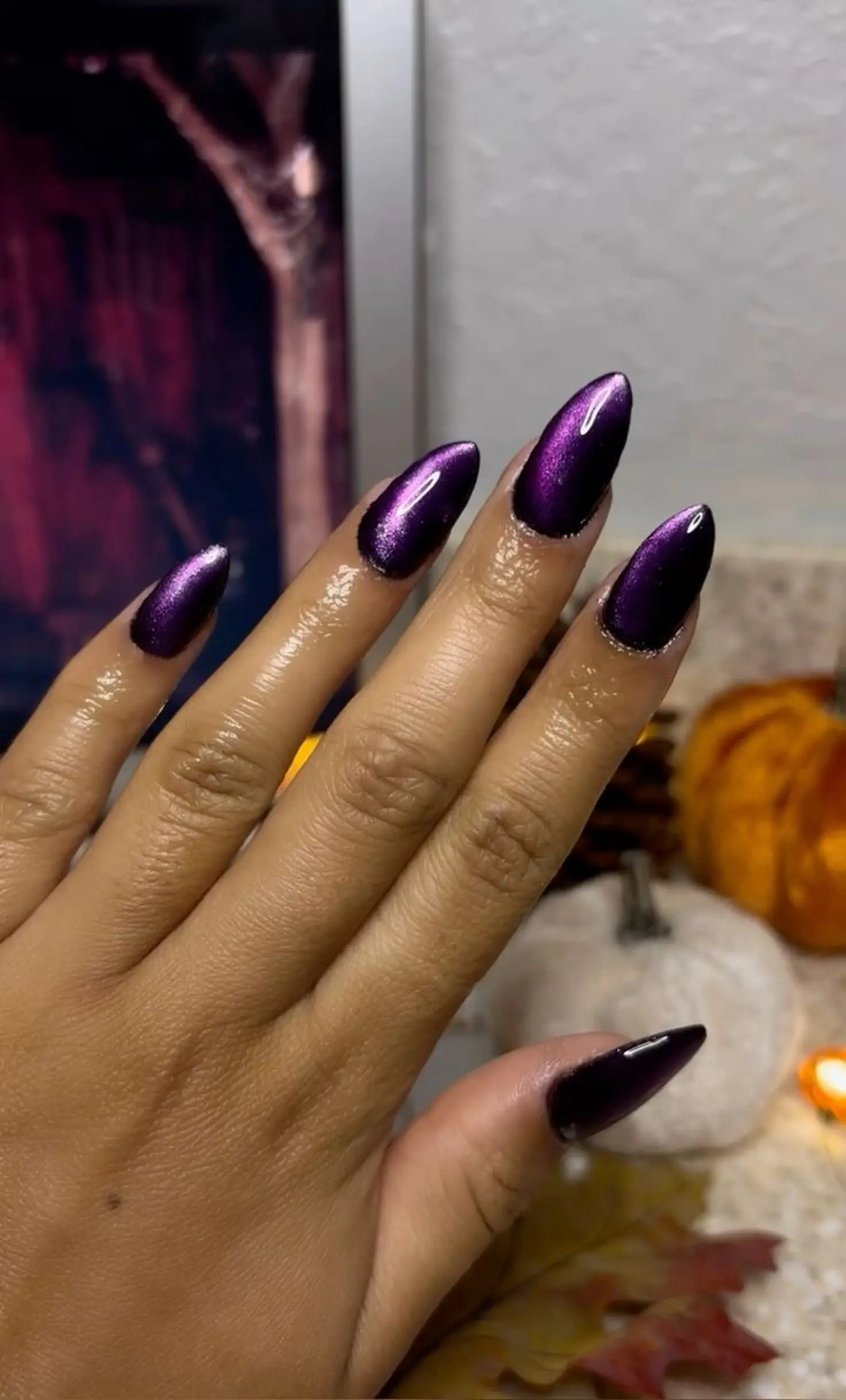Plum purple cat eye almond nails with magnetic velvet finish creating elegant trendy winter manicure perfect for sophisticated look