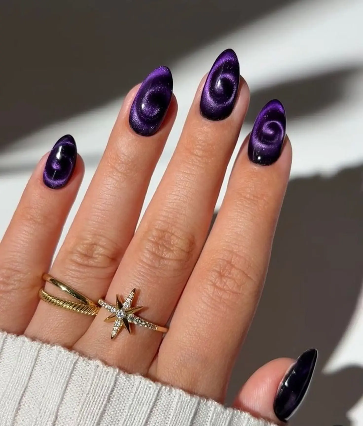 Purple velvet blooming gel cat eye nails using trending technique creating unique dimensional winter manicure design perfect for 2025