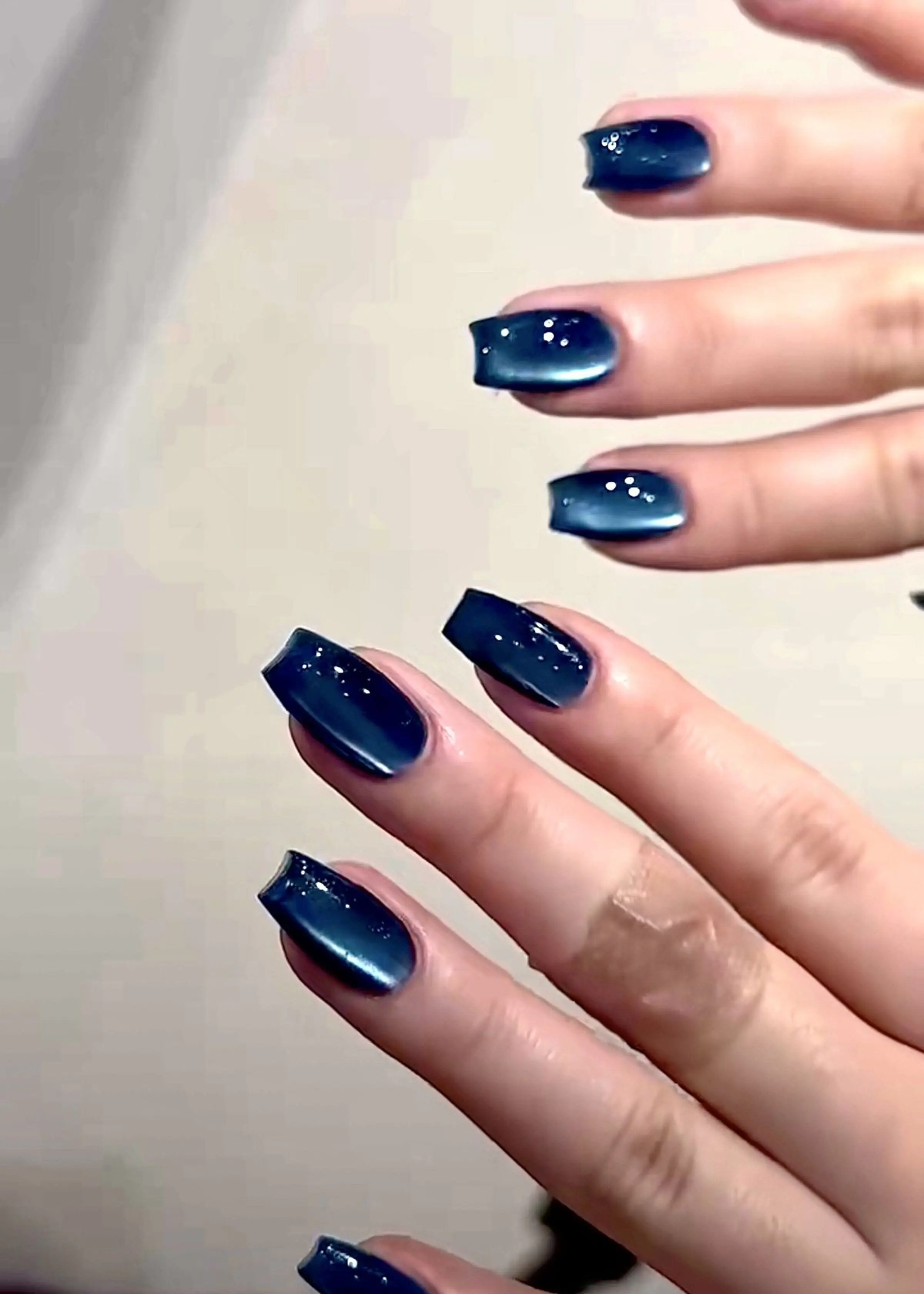 Sapphire blue cat eye nails with magnetic velvet finish creating dimensional jewel tone winter manicure perfect for luxury events