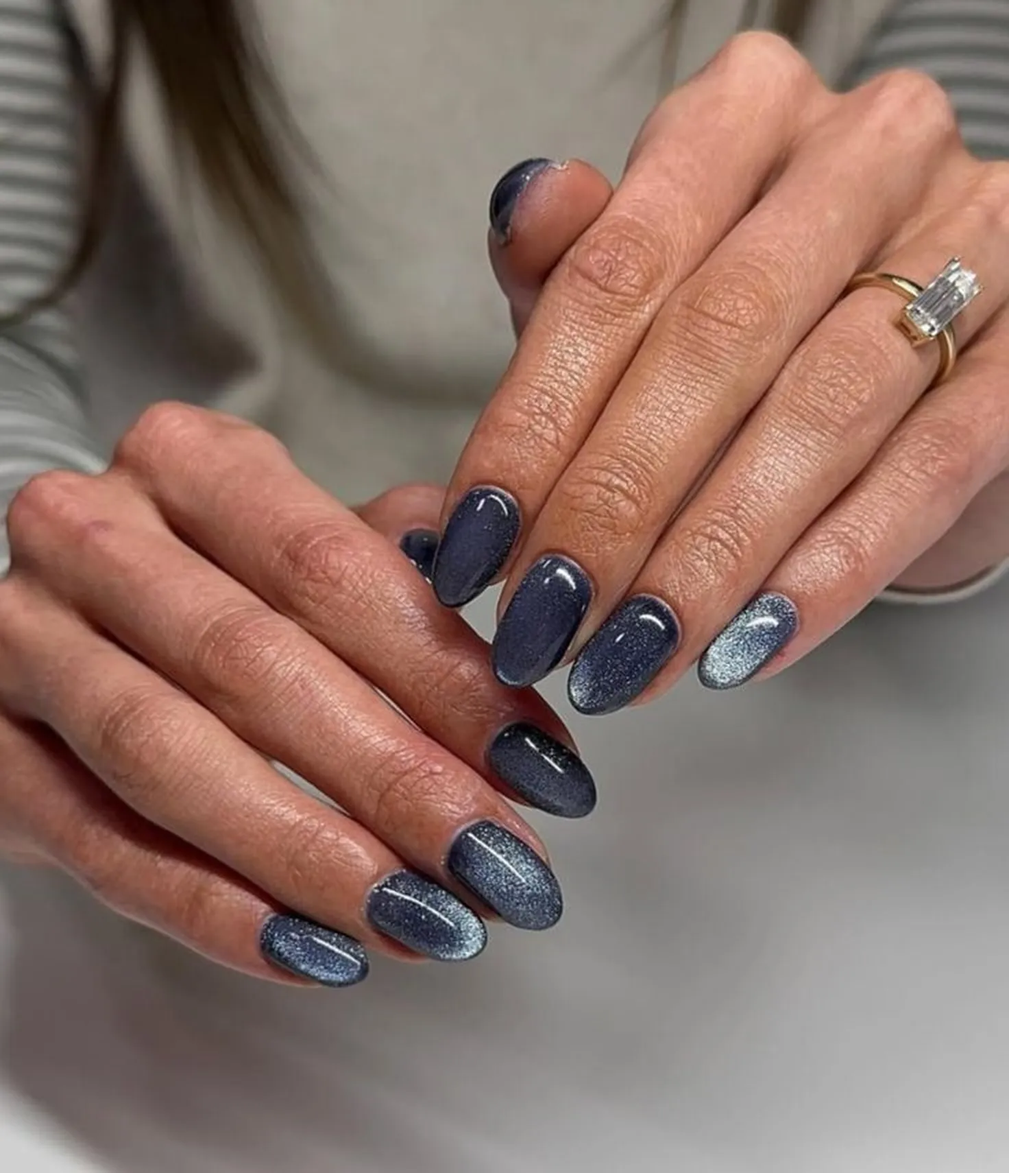 Slate blue velvet short nails with cat eye magnetic creating soft dimensional winter manicure perfect for understated elegant style