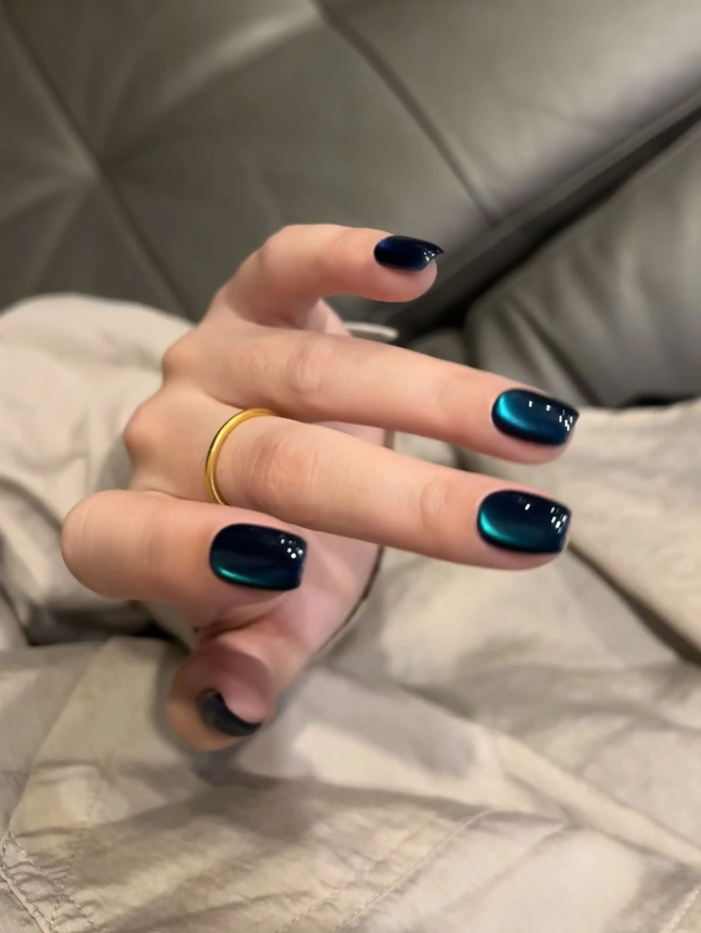 Teal blue magnetic cat eye nails with dimensional finish creating striking winter party manicure perfect for festive celebrations 2025